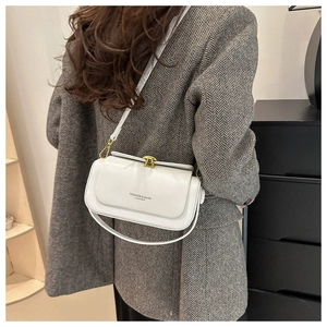 Back view of model wearing a white leather box bag with gold buckle and fashion text