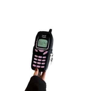 Retro mobile phone mini crossbody bag in black patent leather with Delete My Number slogan