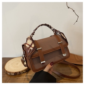 Brown canvas and leather shoulder bag with decorative scarf on handle and strap