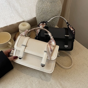 Chic woven underarm bag in beige and black with decorative scarf handle and metal buckles