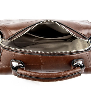 Dark brown leather shoulder bag featuring spacious interior with herringbone lining