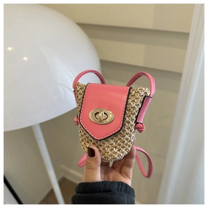 Detail of a mini woven straw crossbody bag with pink leather flap and gold twist lock