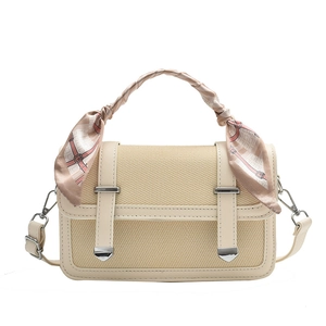 Cream beige woven crossbody bag with silk scarf handle and adjustable strap