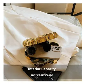 Interior view of gold flower clutch bag showing space for phone and lipstick