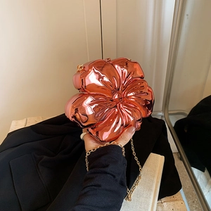 Pink metallic flower-shaped chain crossbody bag with rose gold mirror finish and petals