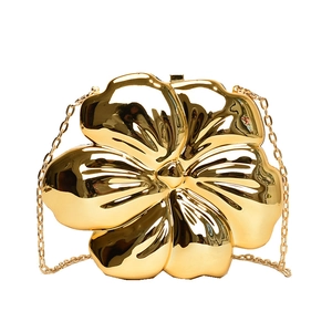 Elegant gold metal floral clutch bag with a mirror finish and delicate chain strap
