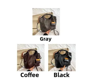 Minimalist faux leather tote bags shown in grey, coffee, and black with mini charm details