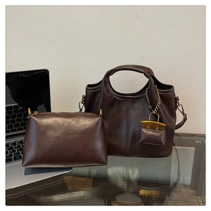 Detail of dark brown vintage leather tote bag set with matching small zipper pouch