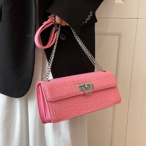 Close-up of pink crocodile texture shoulder bag with silver D-ring lock detail