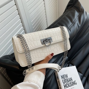 White crocodile embossed crossbody bag with silver chain strap and metal lock detail