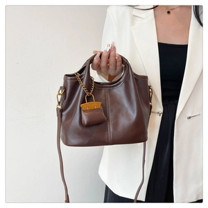 Dark brown leather tote bag with stylish mini charm and detachable shoulder strap