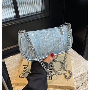 Blue denim underarm bag with silver sequins and metallic chain strap in Y2K style