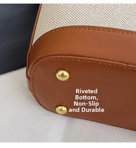 Detail of reinforced handbag base with gold metal rivets for wear resistance