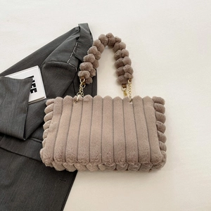 Chic taupe plush tote bag with vertical stripes and fluffy ball handle with gold chains