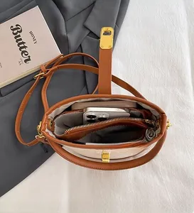 Interior view of contrast stitch bucket bag showing spacious storage and gold clasp