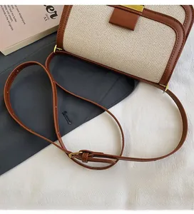 Detailed view of vintage crossbody bag with canvas leather patchwork and metal clasp