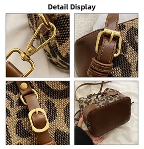 Close-up of leopard print bucket bag featuring premium gold hardware and leather details