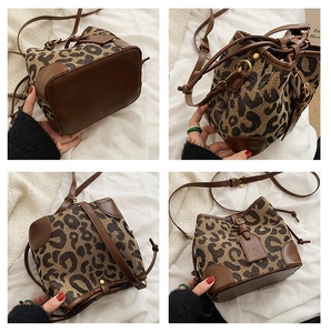 Macro detail of leopard canvas bucket bag with brown leather base and drawstring