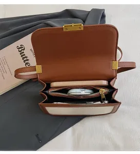 Top view of open retro shoulder bag showing interior compartments and golden twist lock