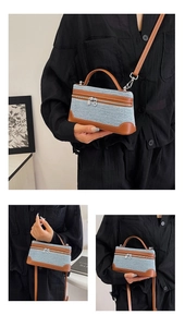 Detail of vintage denim and brown leather mini square bag with silver hardware