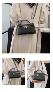 Detail of grey wool vanity case with black leather trim and silver hardware