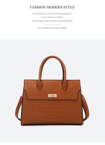 Detail of brown contrast leather tote with crocodile texture and gold twist lock