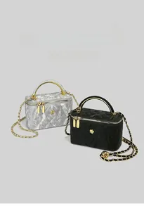 Detail of silver marble and black quilted mini box bags with gold ring handles
