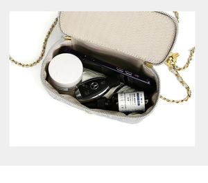 Top view of quilted leather chain bag interior showing storage space for essentials