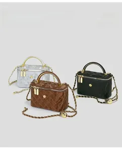Three quilted vanity shoulder bags with golden top handles and chain straps in three colors