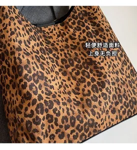 Close-up of leopard print tote bag showing premium canvas texture and stylish black piping