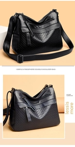 Close-up of black lychee grain leather bag with quilted rhombic texture and multi-zippers