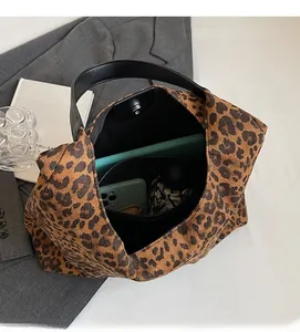 Top view of leopard print handbag showing spacious interior with zipper pocket and magnetic snap