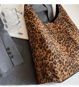 Detailed view of leopard print tote bag styled with blazer for a chic autumn look