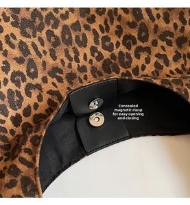 Macro shot of the leopard print handbag showing a hidden magnetic snap closure