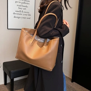 Fashionable brown leather tote bag with lychee texture shown on model for daily commuting