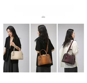 Detail view of crocodile embossed leather bags in cream, brown and burgundy with straps