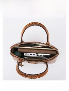 Spacious interior of brown crocodile pattern handbag holding iPad, phone and umbrella