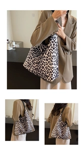 Detailed view of leopard print tote bag with black wide shoulder strap and large capacity