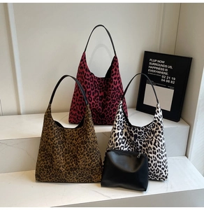 Detailed view of leopard print shoulder bags in red, brown, and black patterns