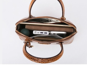 Interior view of brown crocodile embossed bag showing spacious compartment and pockets