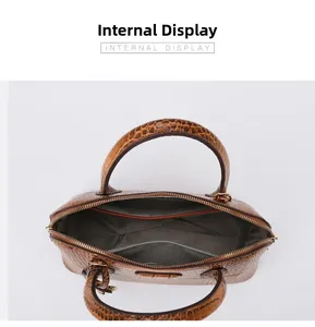 Macro view of brown faux crocodile handbag interior with multiple compartments