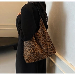 Close-up of leopard print hobo shoulder bag styled with a dark winter wool coat