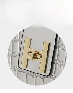 Close-up of silver crocodile texture bag with premium gold H-shaped metal twist lock