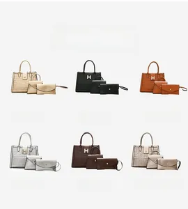 Detail view of the 3-piece bag set with crocodile pattern and golden H-shaped metal buckle