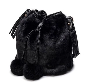 Detail of black faux fur bucket bag featuring plush texture and drawstring pom poms