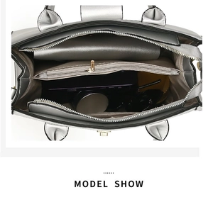 Detailed interior of a silver tote bag showing spacious compartments and zip pocket