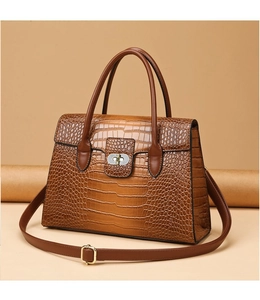 Close-up of retro brown tote bag with crocodile texture and metallic twist-lock closure