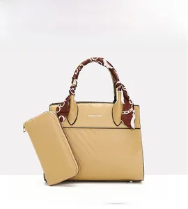Close-up of beige PU leather tote bag set with decorative scarf handle and matching wallet