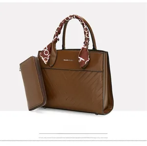 Brown leather tote bag set with V-shaped quilting and decorative handle scarf