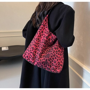 Pink leopard print large tote bag with black straps for women worn over shoulder